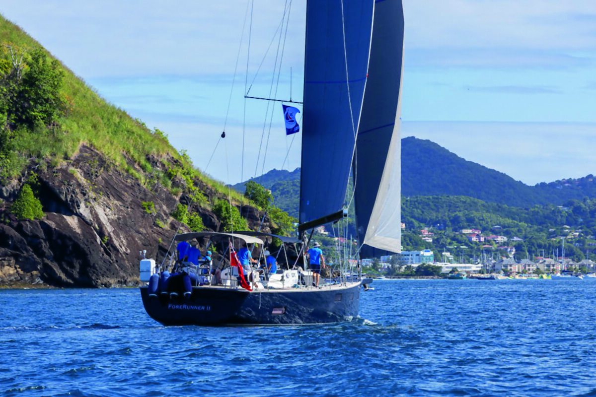 Blue-hulled sailing yacht under sail